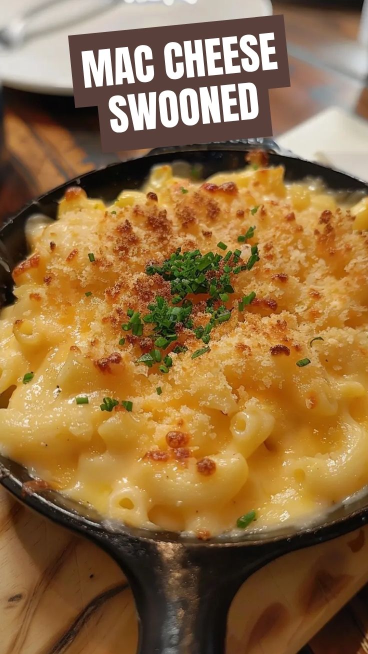 A close-up of a bubbling, golden-brown baked mac and cheese casserole, fresh from the oven.