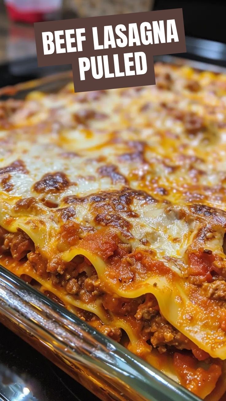 A bubbling dish of savory beef lasagna with a golden cheesy top.