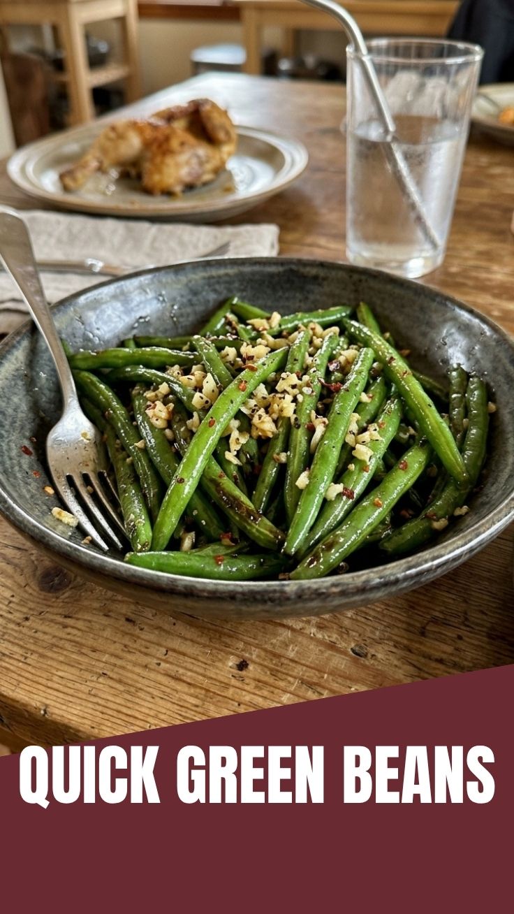Close-up of vibrant green beans sautéed with minced garlic